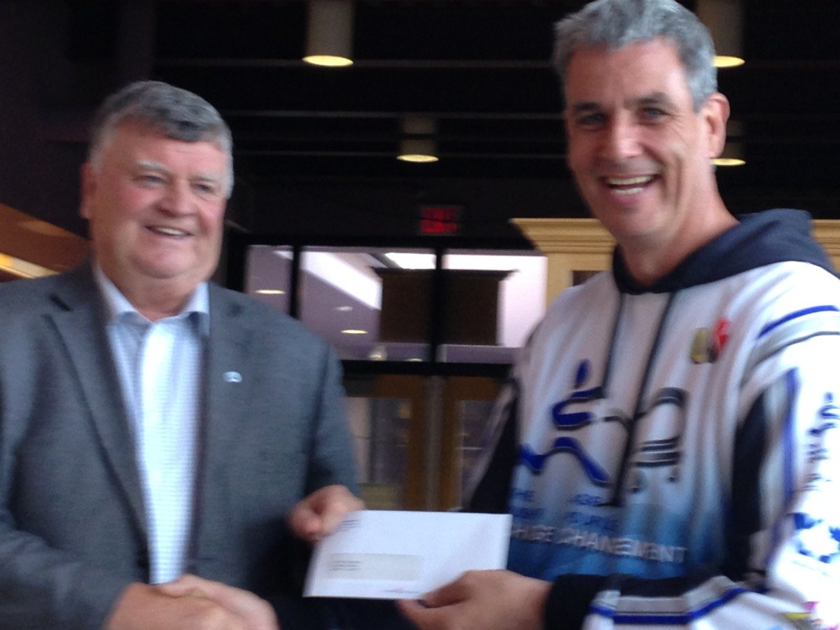 Gander Mayor Claude Elliott making donation